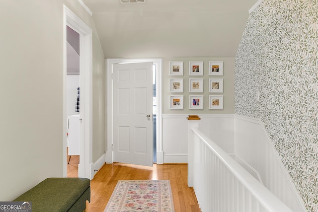 foyer entrance with light hardwood / wood-style flooring and vaulted ceiling