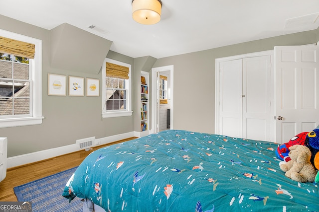 bedroom with wood-type flooring and a closet