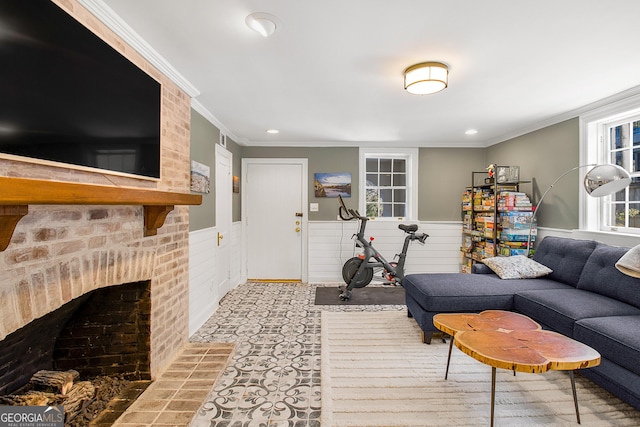 living room with crown molding and a fireplace