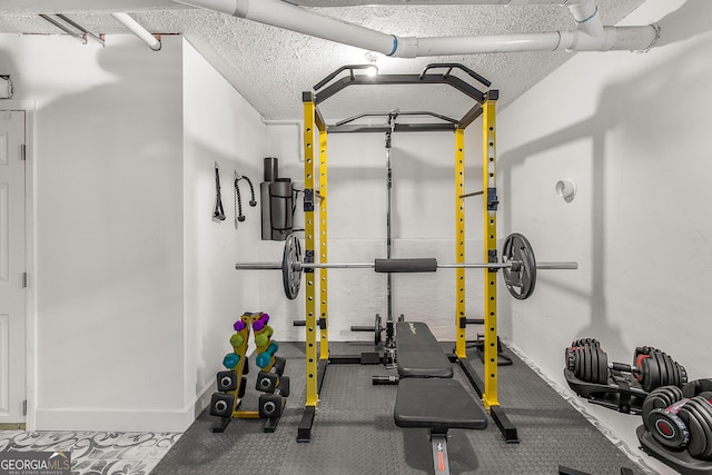 workout room featuring a textured ceiling