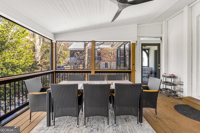 sunroom / solarium featuring ceiling fan, a healthy amount of sunlight, and vaulted ceiling