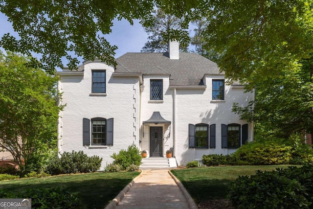 french provincial home featuring a front lawn