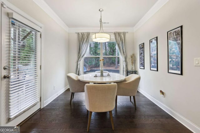 dining room with ornamental molding and dark wood-type flooring