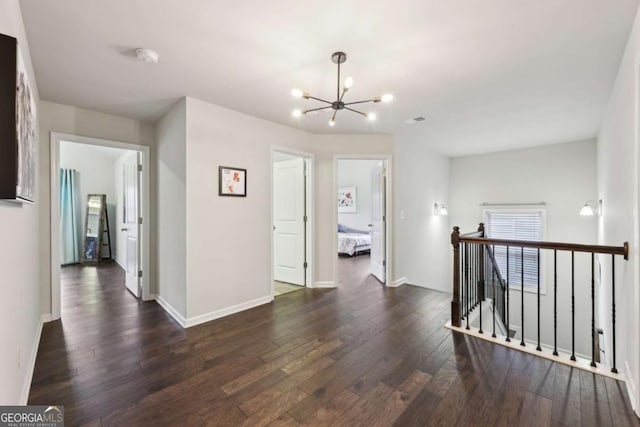 hall featuring a chandelier and dark wood-type flooring