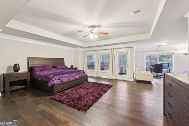 bedroom with access to exterior, a raised ceiling, and ceiling fan