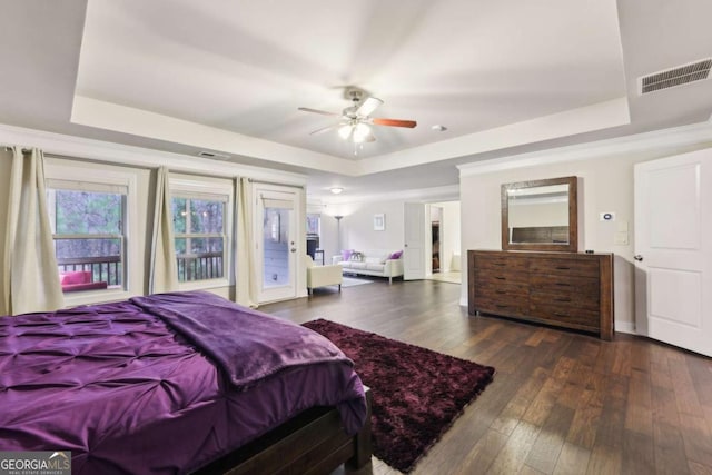 bedroom featuring a tray ceiling, ceiling fan, dark wood-type flooring, and access to outside