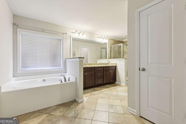 bathroom featuring vanity and independent shower and bath