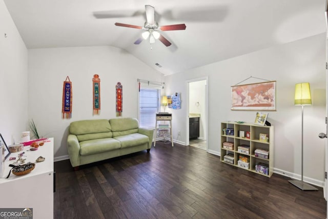 sitting room with ceiling fan, dark wood-type flooring, and vaulted ceiling