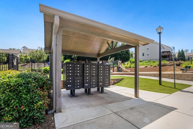 view of property's community featuring a playground and a mail area