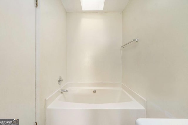 bathroom featuring a tub to relax in