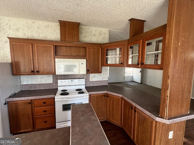 kitchen with white appliances and a textured ceiling