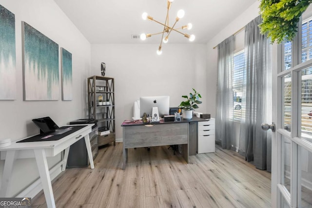 office area featuring light hardwood / wood-style floors and an inviting chandelier