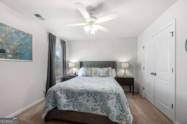 carpeted bedroom with ceiling fan and a closet