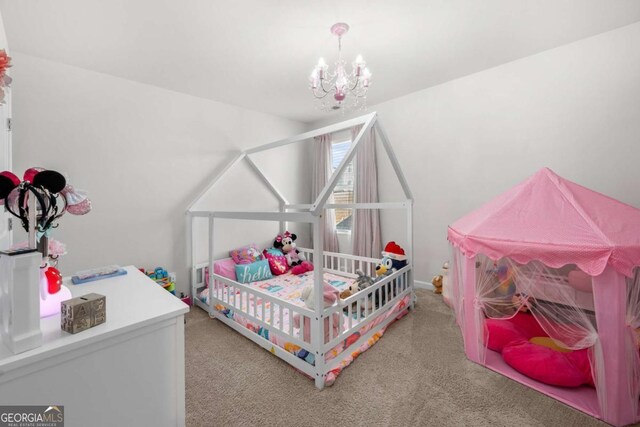 bedroom with carpet floors and an inviting chandelier