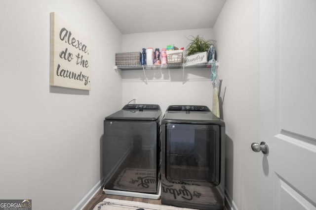 washroom featuring separate washer and dryer and hardwood / wood-style flooring