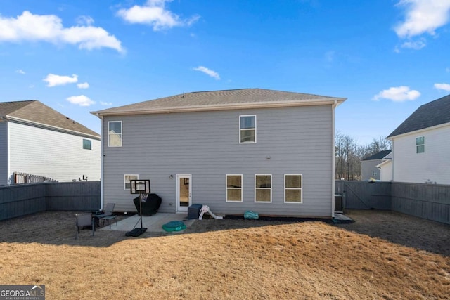 rear view of house featuring a lawn and a patio