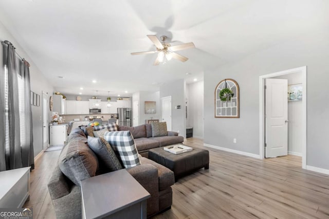 living room with light wood-type flooring and ceiling fan