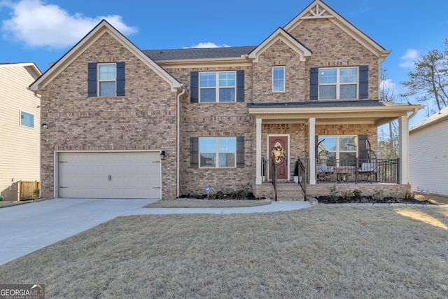 view of front of property with covered porch, a garage, and a front lawn