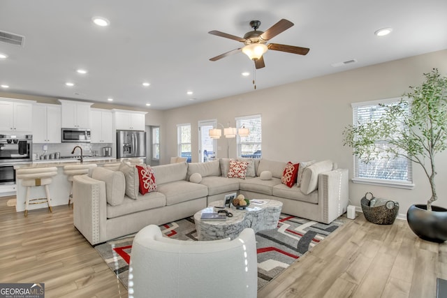 living area featuring visible vents, recessed lighting, and light wood-type flooring