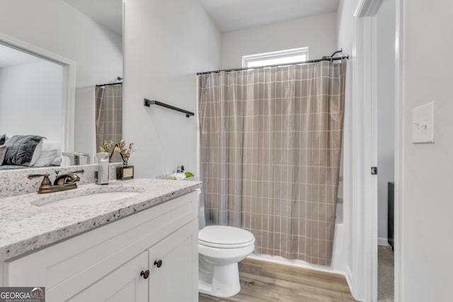 full bath featuring vanity, toilet, and wood finished floors