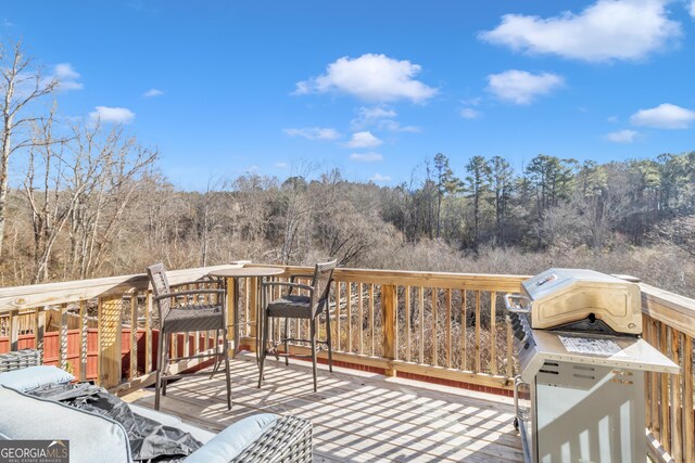 wooden deck featuring a wooded view