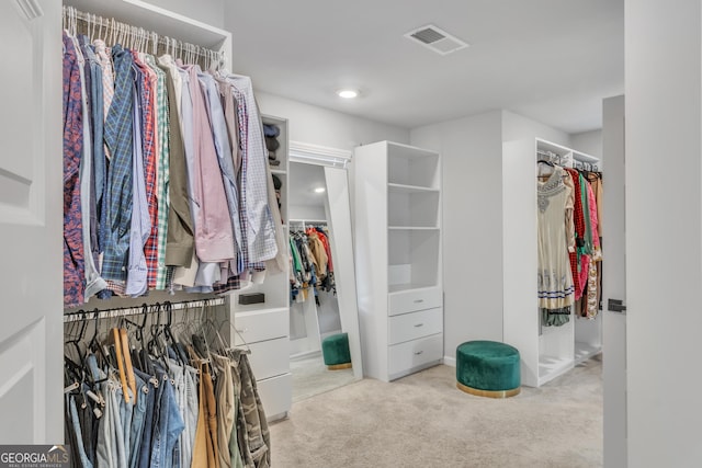 spacious closet with visible vents and carpet floors