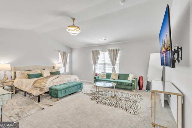 bedroom featuring visible vents, light colored carpet, baseboards, and lofted ceiling