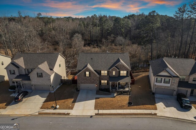 drone / aerial view with a wooded view