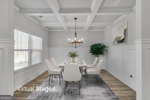 dining room with wood finished floors, visible vents, beam ceiling, a decorative wall, and a notable chandelier