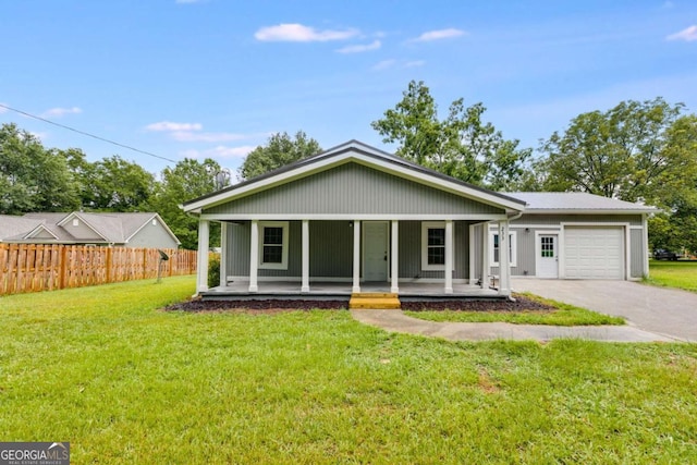 view of front facade with a front yard, a porch, and a garage