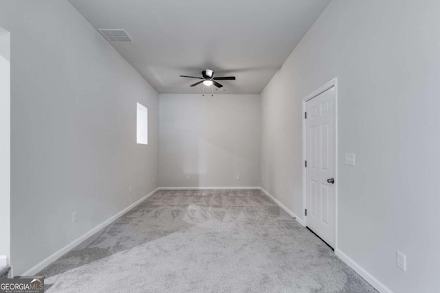 unfurnished room with light colored carpet and ceiling fan