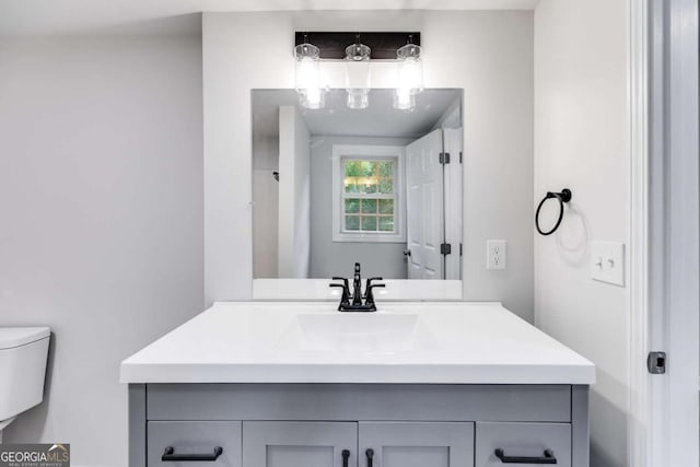 bathroom featuring vanity and toilet