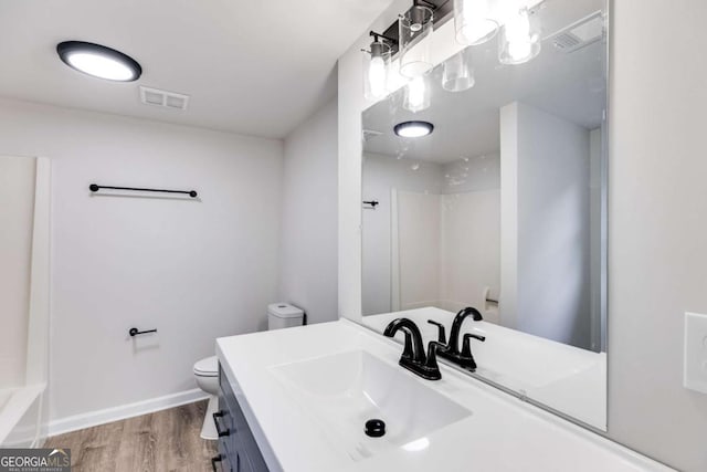 full bathroom with vanity, toilet, wood-type flooring, and tub / shower combination