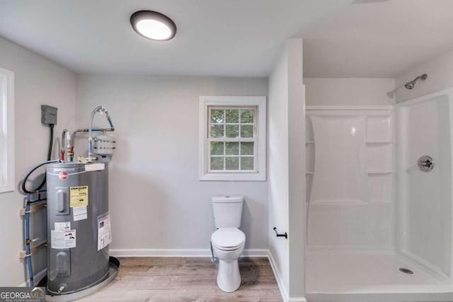 bathroom with toilet, wood-type flooring, electric water heater, and a shower