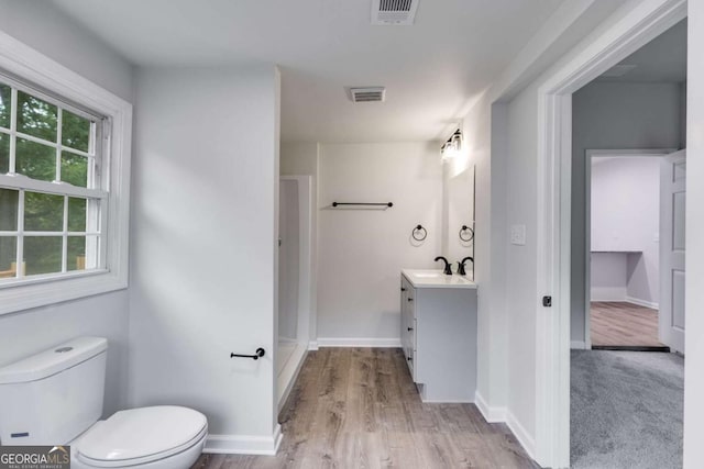 bathroom featuring hardwood / wood-style flooring, vanity, and toilet