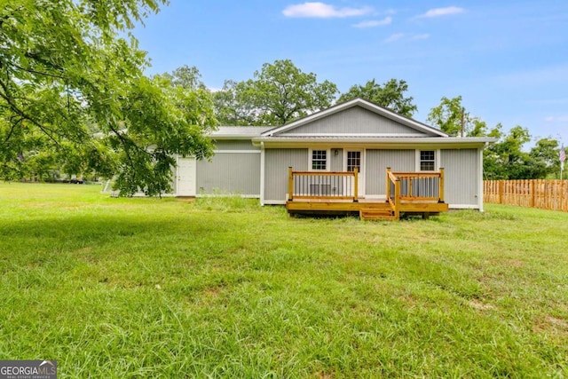 back of house with a yard and a wooden deck