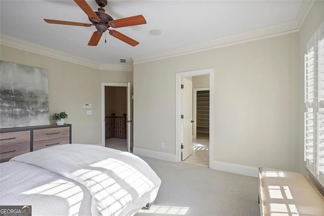 carpeted bedroom with ornamental molding and ceiling fan