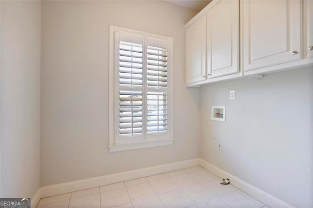 washroom with washer hookup and cabinets