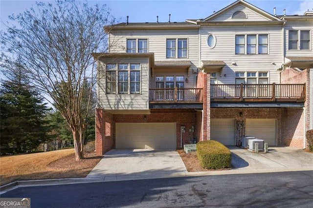 view of property with a garage and central AC unit