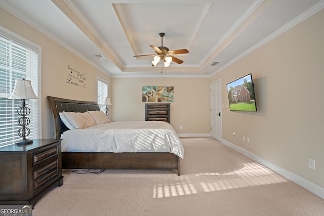 bedroom featuring light carpet, a raised ceiling, ceiling fan, and crown molding