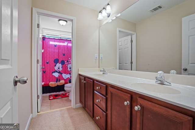 bathroom with vanity and toilet