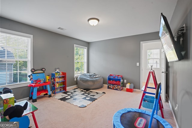 recreation room featuring carpet and a wealth of natural light