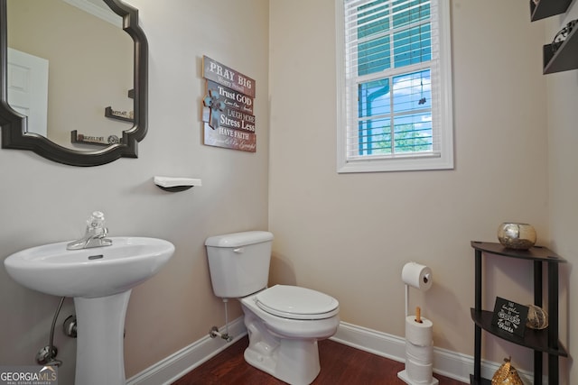 bathroom with toilet and hardwood / wood-style flooring