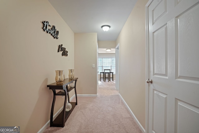 hallway with light colored carpet