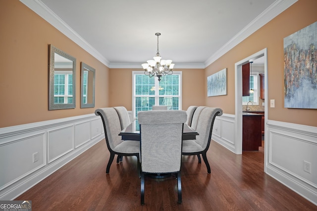 dining area featuring dark hardwood / wood-style floors, ornamental molding, and a chandelier