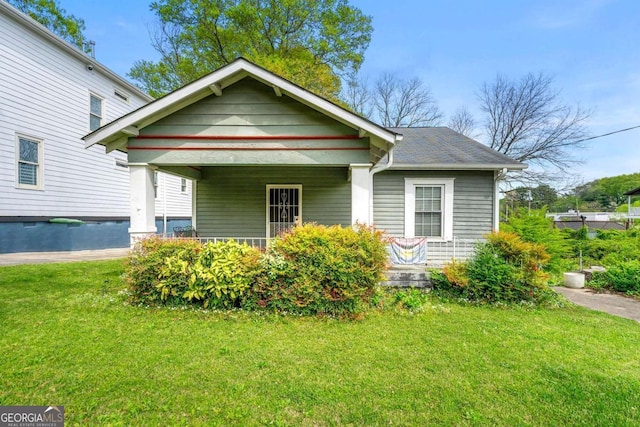 view of front of house with covered porch and a front yard