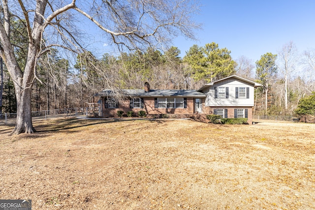 tri-level home featuring a front lawn