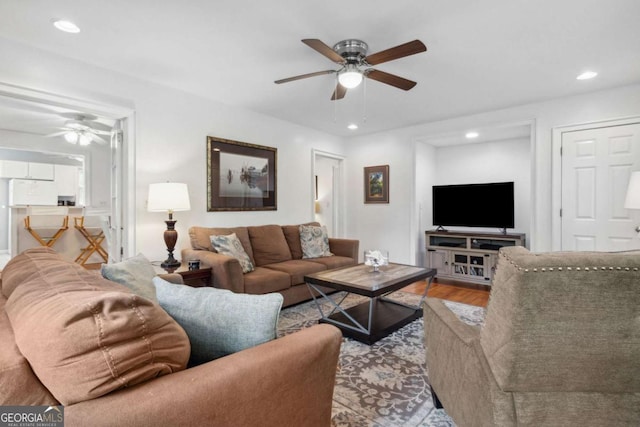 living area with ceiling fan, wood finished floors, and recessed lighting