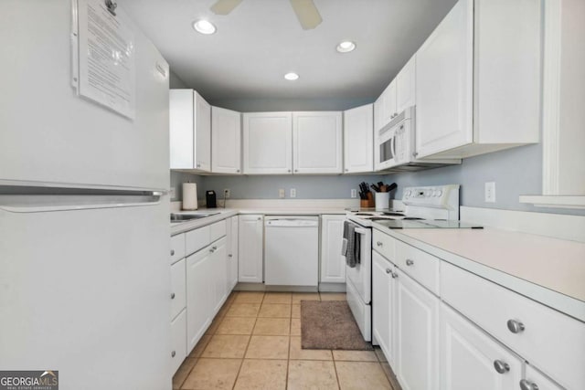 kitchen with white cabinets, white appliances, and light countertops