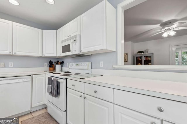 kitchen with a ceiling fan, white appliances, white cabinets, and light countertops